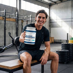 Athlete holding Athletech Purest Creatine 1kg in the gym